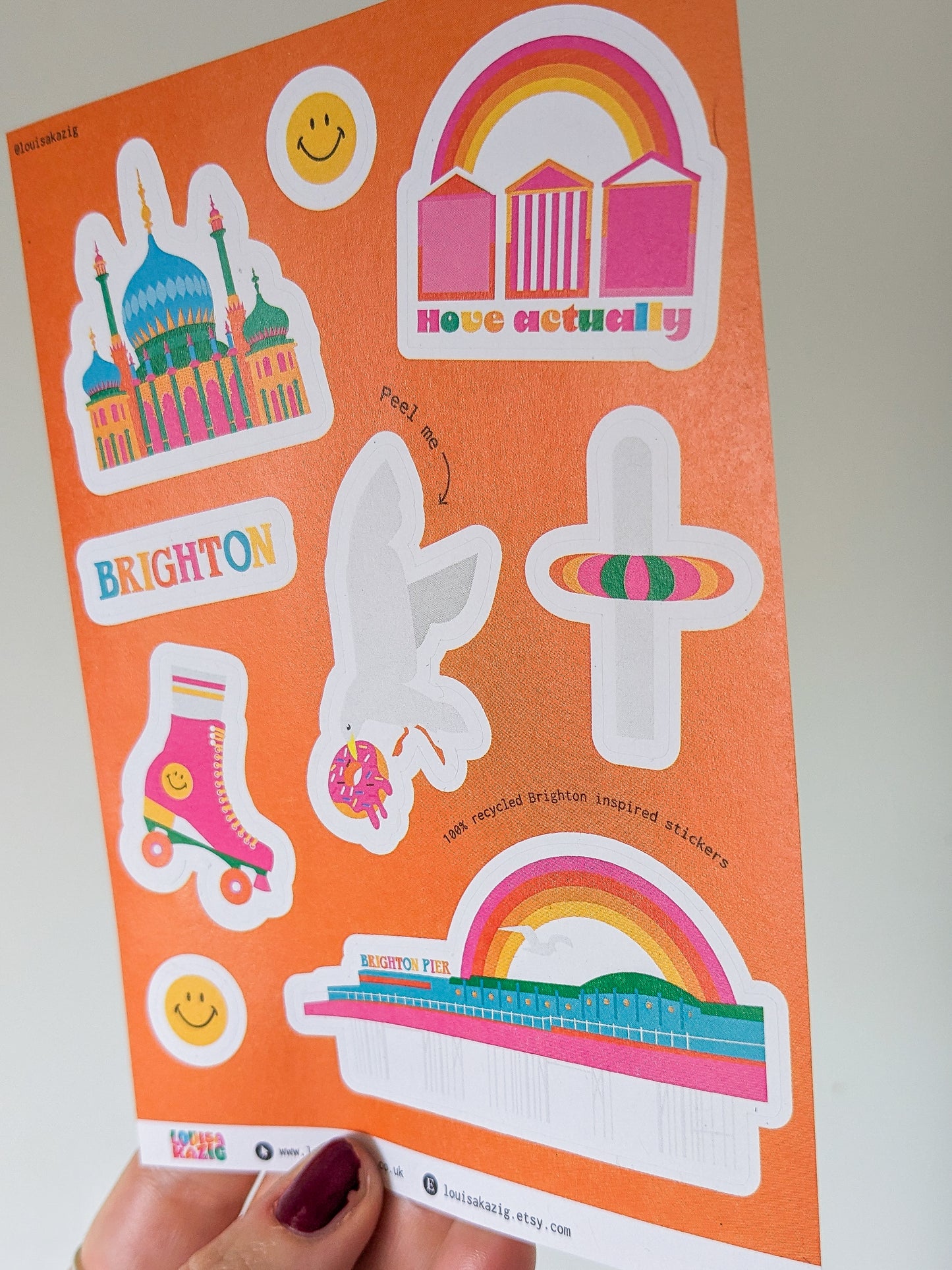a hand holding a colourful sticker sheet